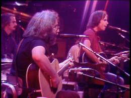 Jerry Garcia and Bob Weir playing acoustic guitars.